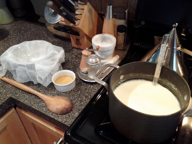 Warming milk for ricotta with equipment/ingredients at the ready